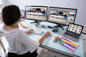 Female Designer Working On Multiple Computer - Electronic Playground Web Design Yuba City